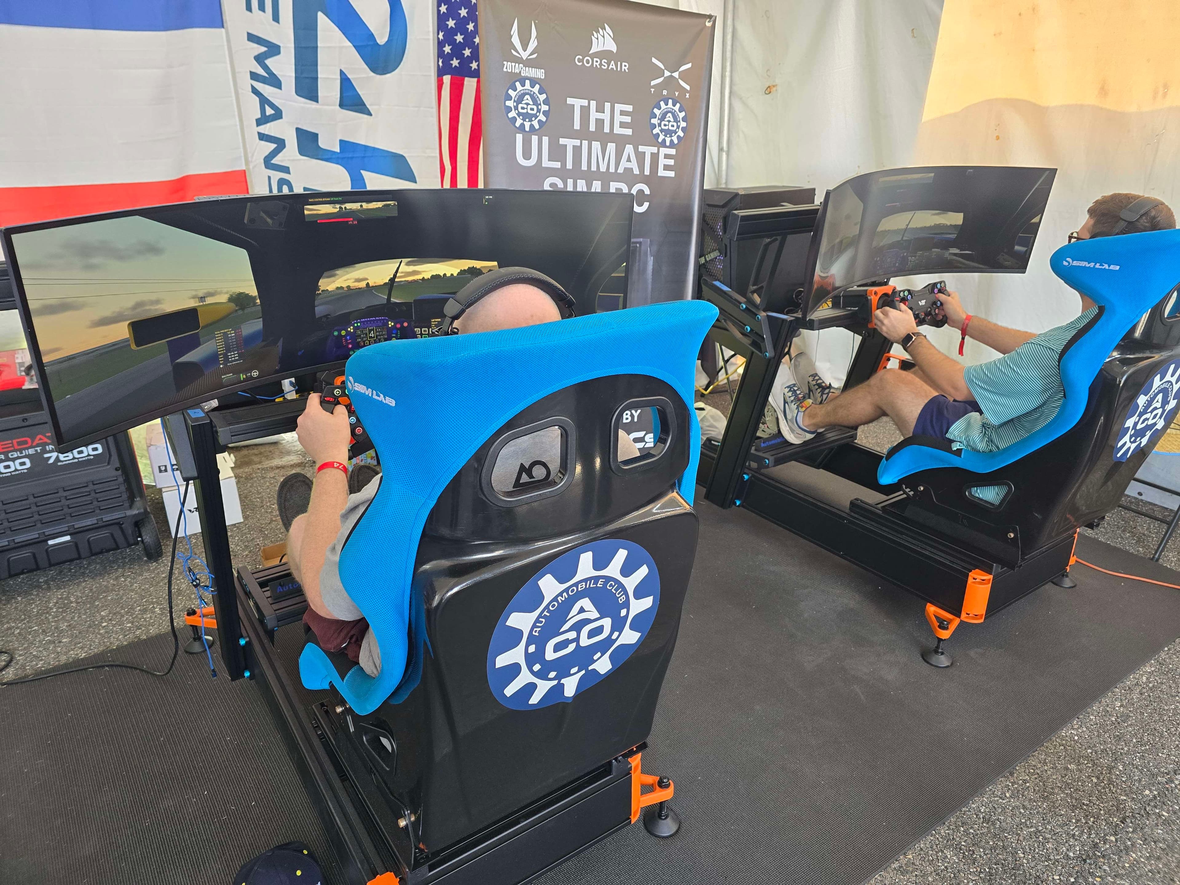 Guests gathered around motorsports-grade racing simulators